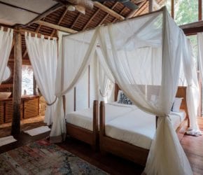 Jungle Lodge bedroom with cosy canopy beds and natural stone bathroom, secluded luxury accommodation, perfect for family at Bawah Reserve, Indonesia