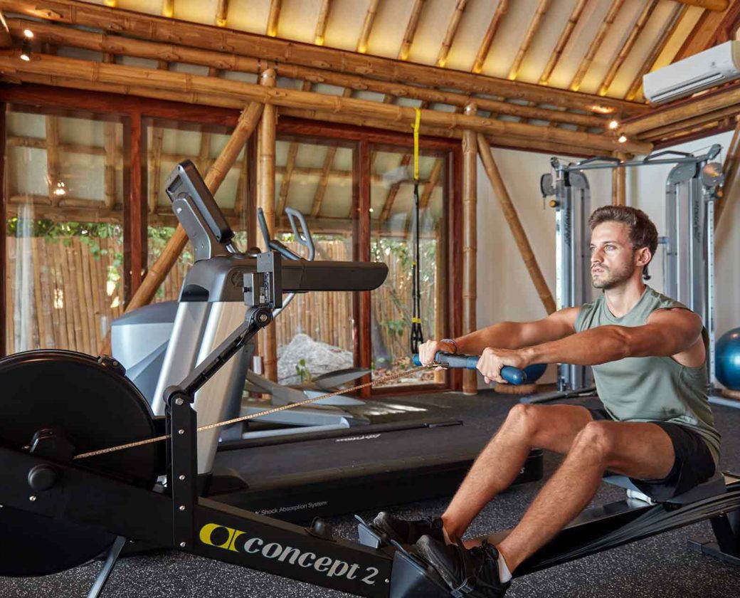 fitness_man_using_rowing_machine_at_aura_gym