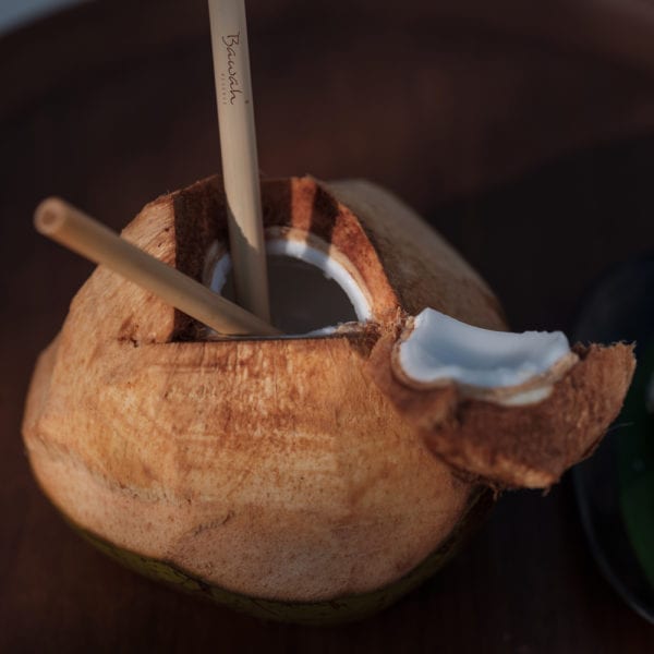 Coconut with a bamboo straw at Bawah Reserve, Indonesia