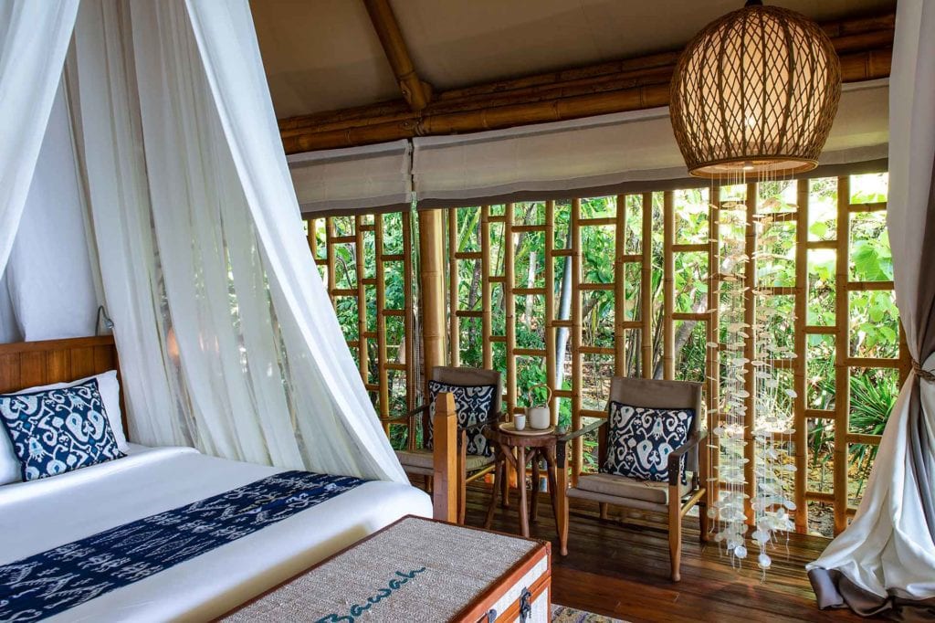 Tented Garden Suite bedroom with canopy sides up, accommodation at Bawah Reserve, Indonesia