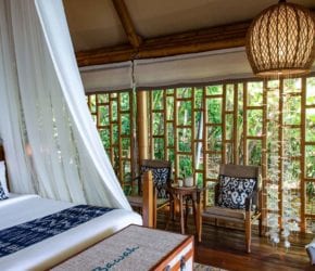Tented Garden Suite bedroom with canopy sides up, accommodation at Bawah Reserve, Indonesia