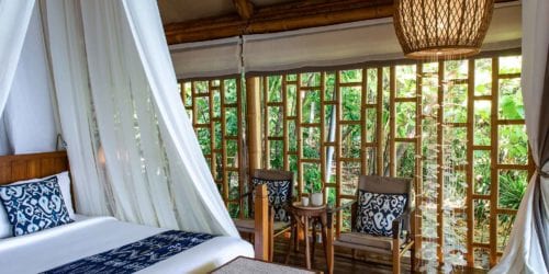 Tented Garden Suite bedroom with canopy sides up, accommodation at Bawah Reserve, Indonesia