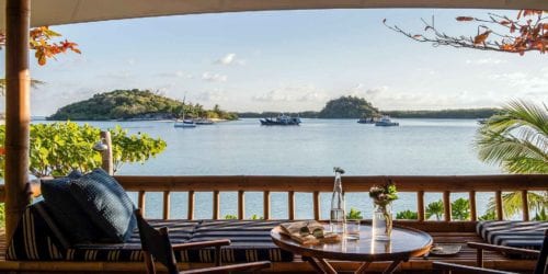 Beach Suite Verandah with a view of the boats in the lagoon at Bawah Reserve, Indonesia