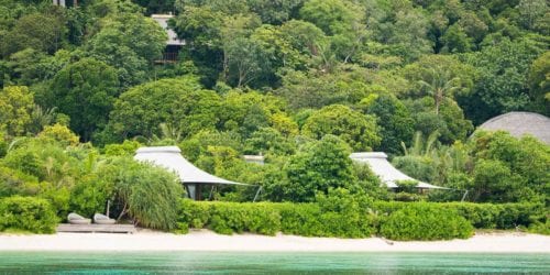 Beach Suites lining along the beach front, on private island sustainable resort Bawah Reserve, Indonesia