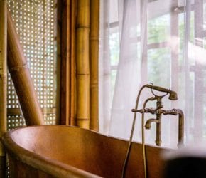 Freestanding copper baths in the garden and beach suite accommodation at Bawah Reserve, Indonesia