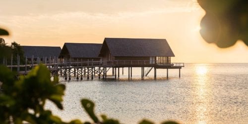 Romance: weddings, anniversaries, proposals and honeymoons - Couples Double Aura spa room Overwater bungalow by sunrise, on private island resort Bawah Reserve, Indonesia