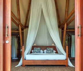 Pool Villa bedroom and canopy bed, deck and private pool, on private island sustainable resort Bawah Reserve, Indonesia