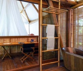 Copper bath, desk and bamboo towel ladder in the beach suite at Bawah Reserve, Indonesia