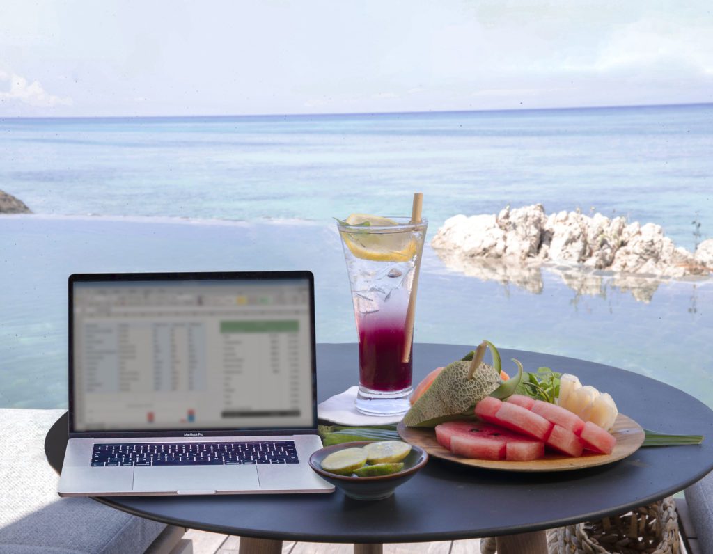 workcation laptop by the pool