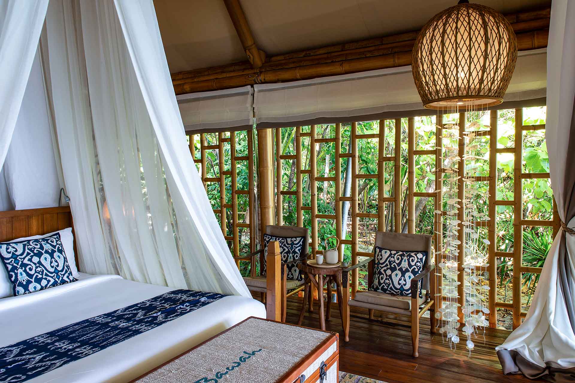 suite bedroom with open side showing outside nature and bamboo frame