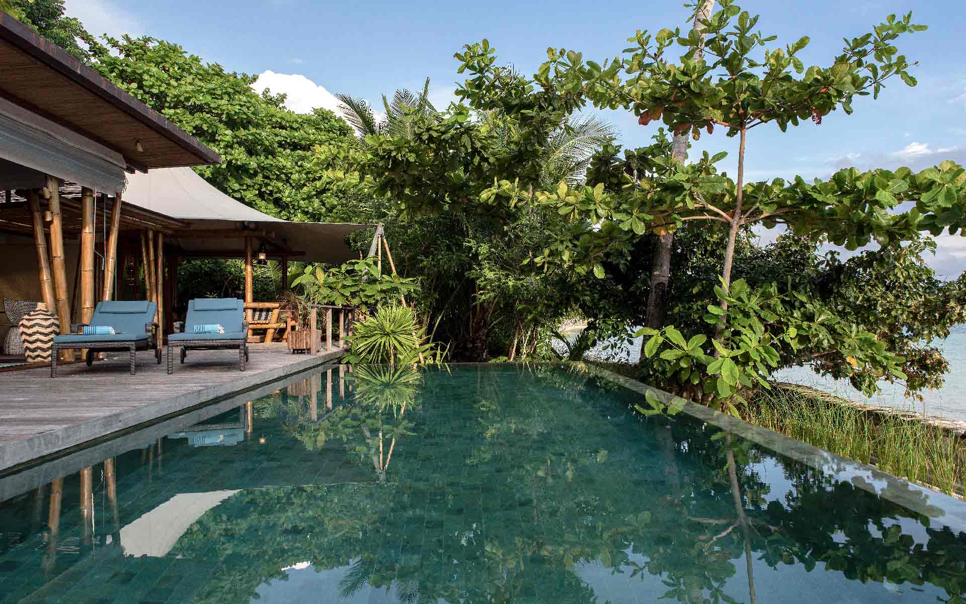 Escape to our Two-bedroom Infinity Pool Villa at Bawah Reserve. Experience open-air luxury, private infinity pool, and captivating sea views.