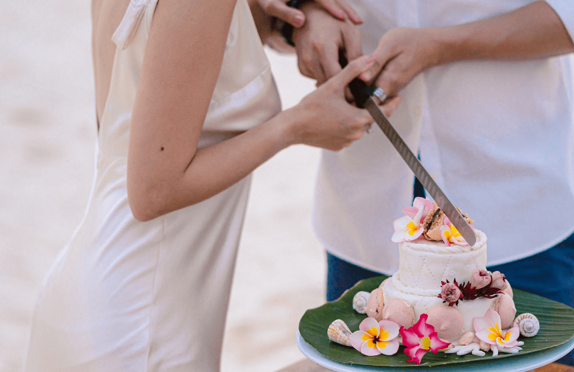 Romance cutting the wedding cake, WEDDINGS & VOW RENEWAL CEREMONIES at Bawah Reserve, Indonesia.