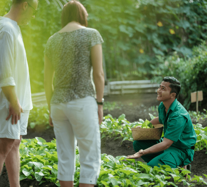 Activities at Bawah Reserve, Indonesia, Permaculture garden tour. Head gardener shows guests the fruit and vegetables we grow at Bawah Reserve.