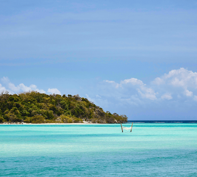 Activities, relax in a beautiful hammock in the sea on private island resort, Bawah Reserve, Indonesia.