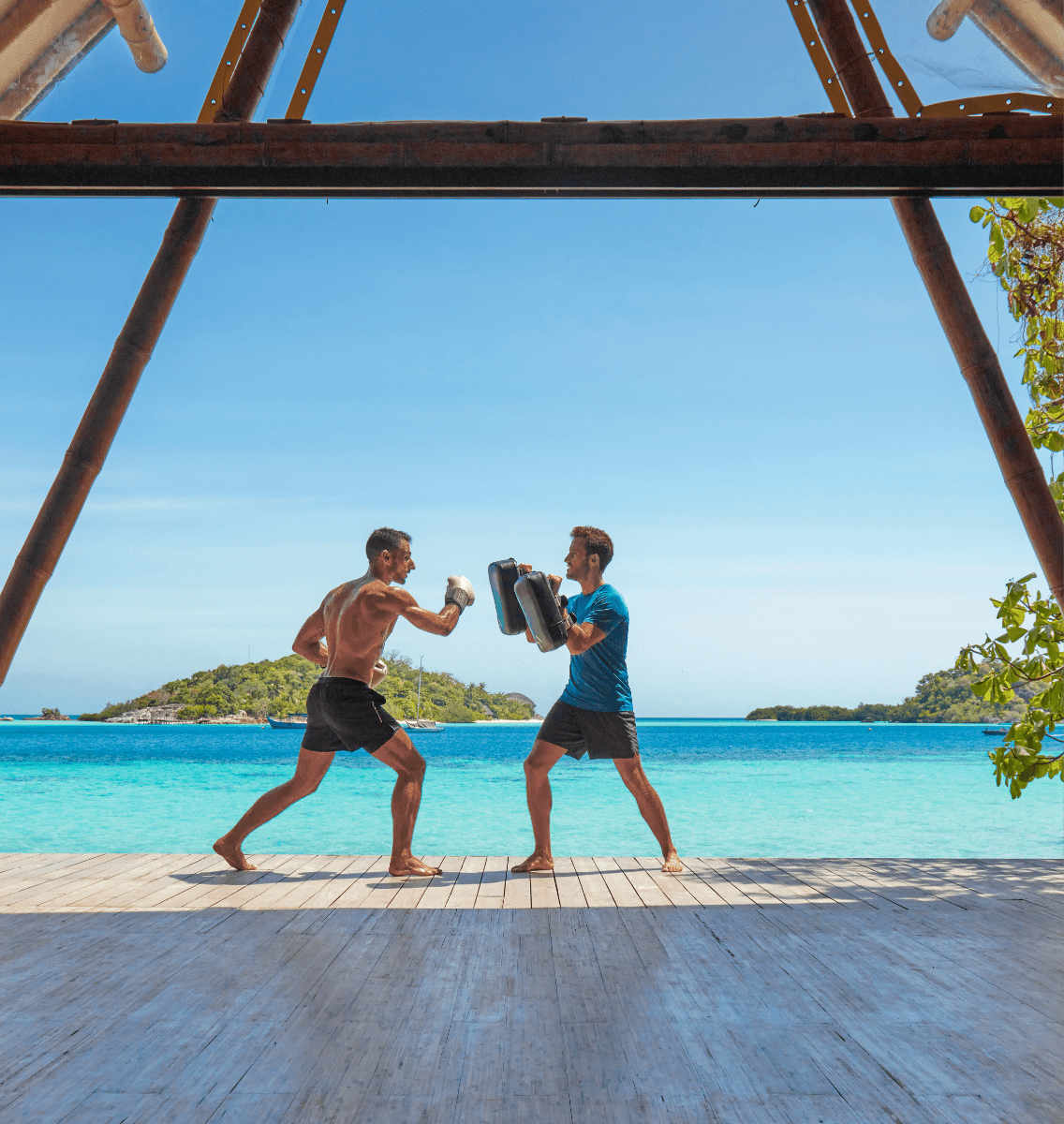 Guests at the Aura wellbeing centre yoga deck practicing boxing, activities at Bawah Reserve, private island hotel and resort, Indonesia