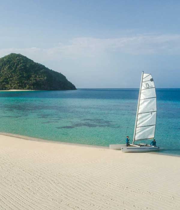 Activities at Bawah Reserve, private island resort, Indonesia. Catamaran sailing boat.