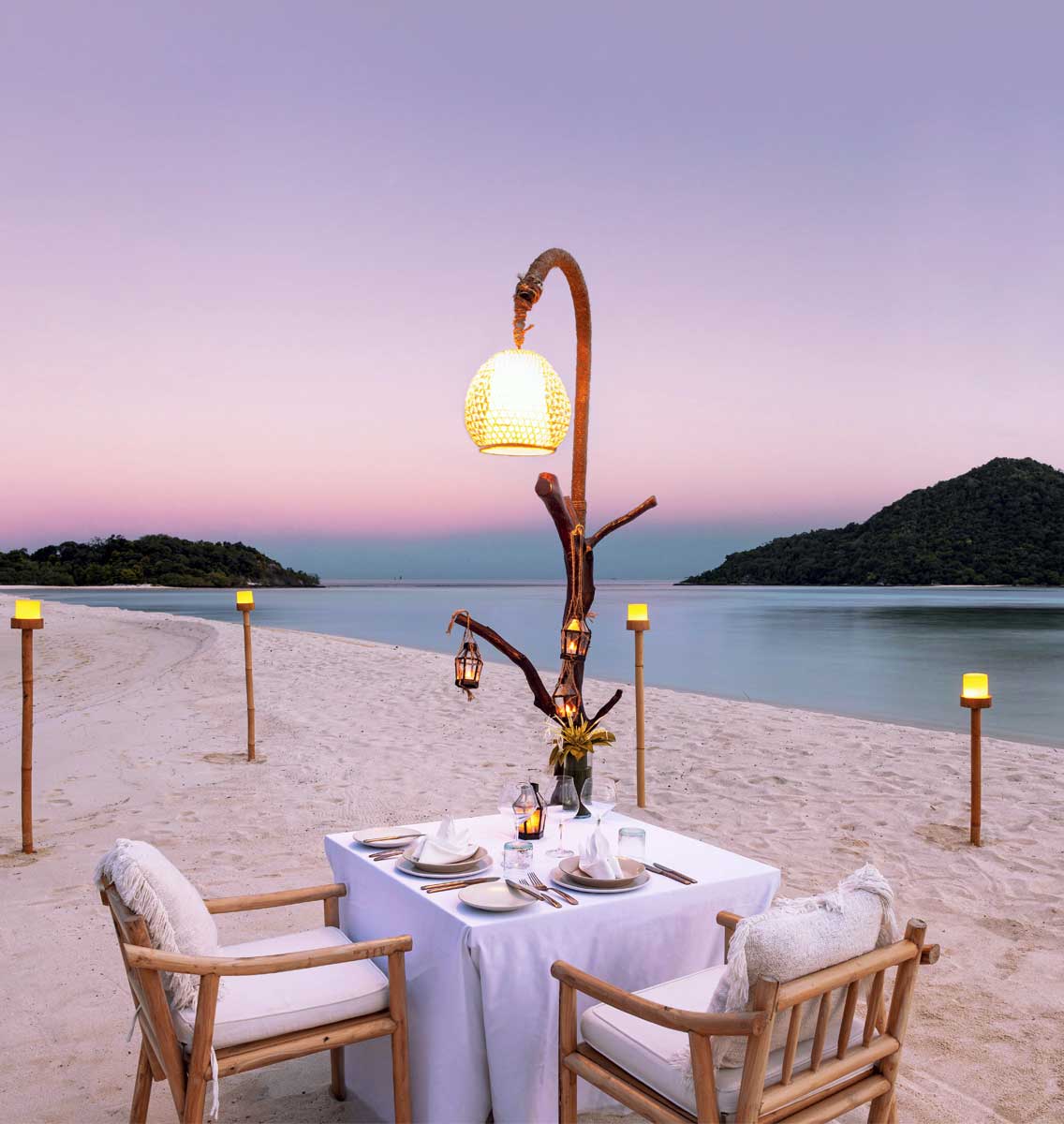 Romantic, private, candlelit dinner for two on the beach at Bawah Reserve island hotel and resort, Indonesia.