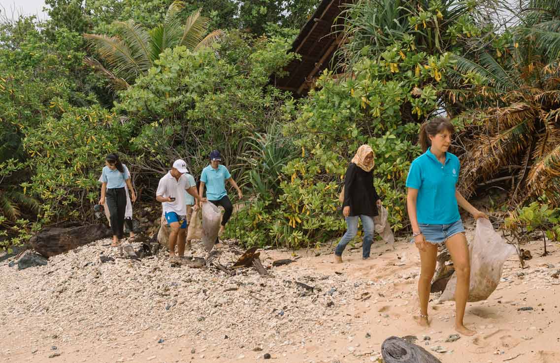 Conservation staff beach clean up at Bawah Reserve, Indonesia