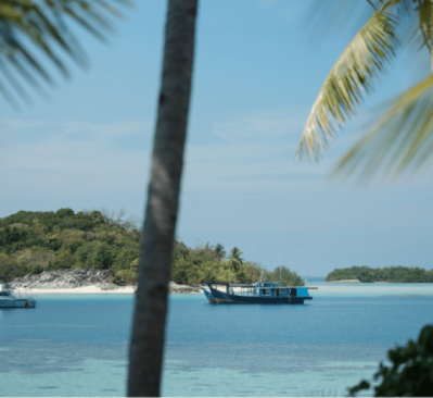 Local boats in the lagooon moored at Bawah Reserve, Indonesia.